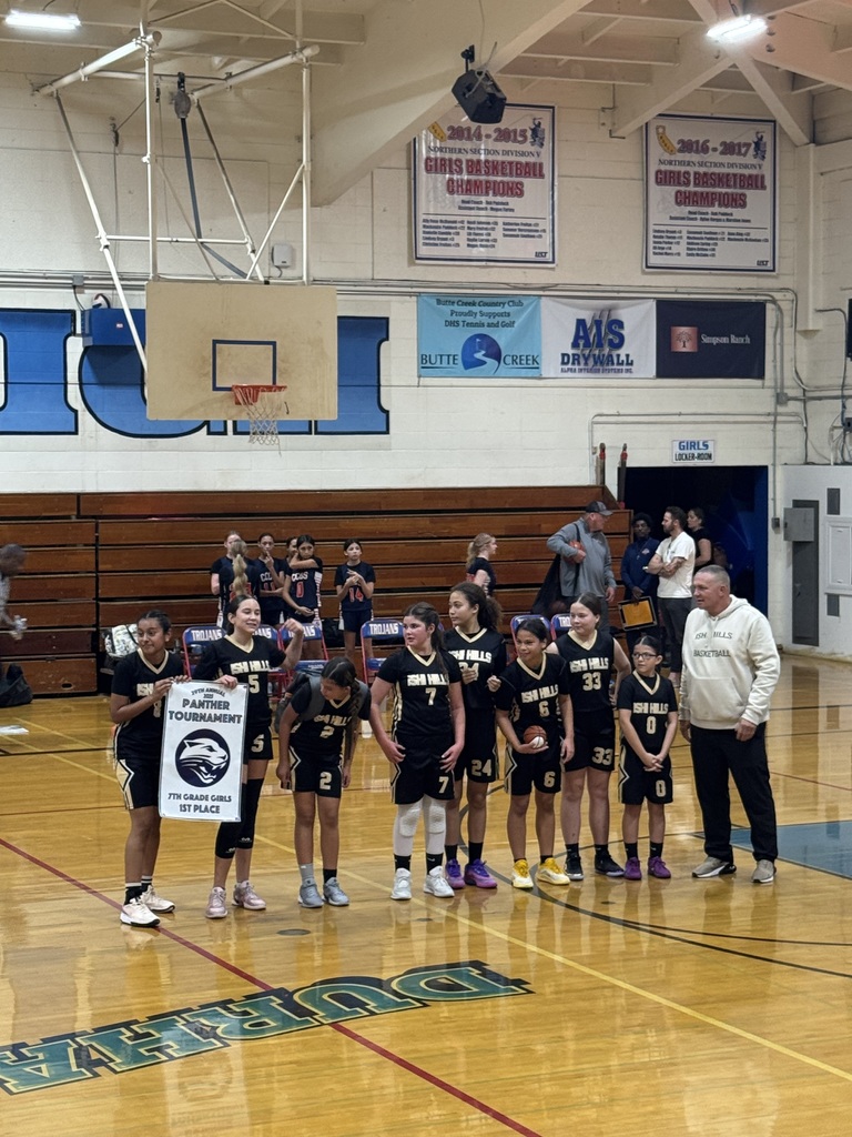 The Team receiving a 1st place banner in a gym