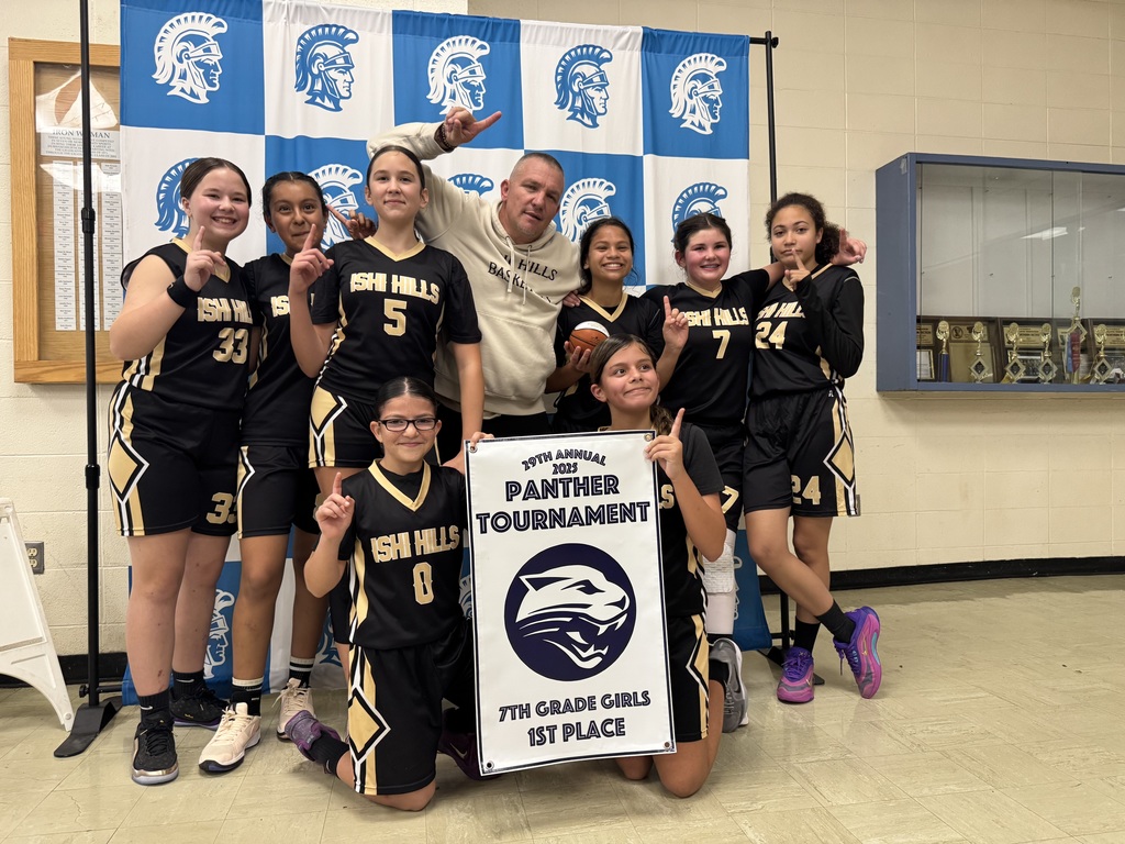 The team holding up #1's with the 1st place banner.