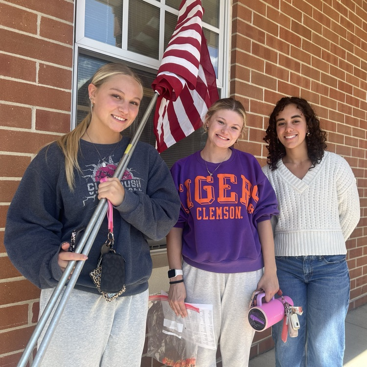 NHS student setting up flags throughout the city!