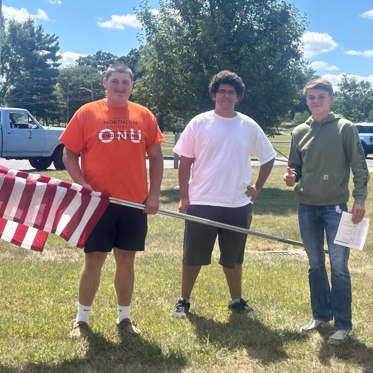 NHS student setting up flags throughout the city!