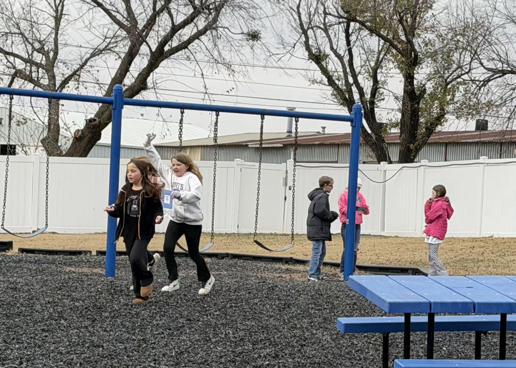 Students solving math problems on the playground.
