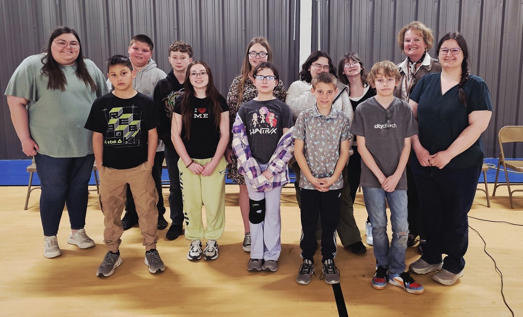 Group picture of spelling winners with judges.