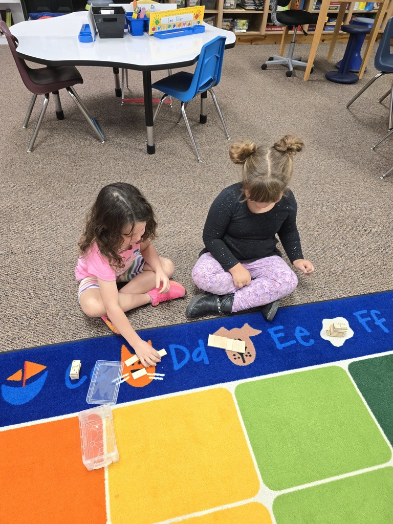 Mrs. Schultz's kindergarten class is using dominoes to help them learn about greater numbers.
