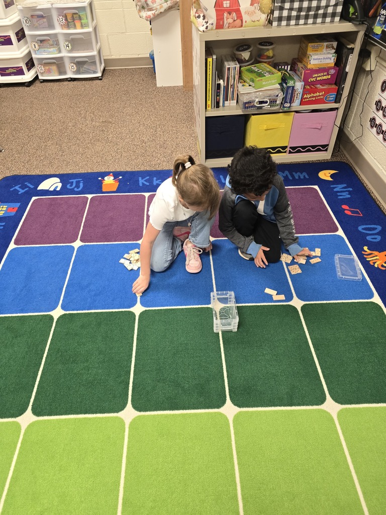 Mrs. Schultz's kindergarten class is using dominoes to help them learn about greater numbers.