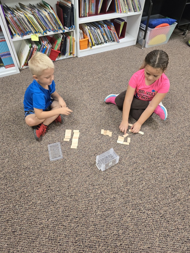 Mrs. Schultz's kindergarten class is using dominoes to help them learn about greater numbers.