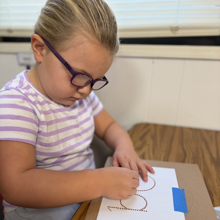 AM Preschool working on their fine motor skills.