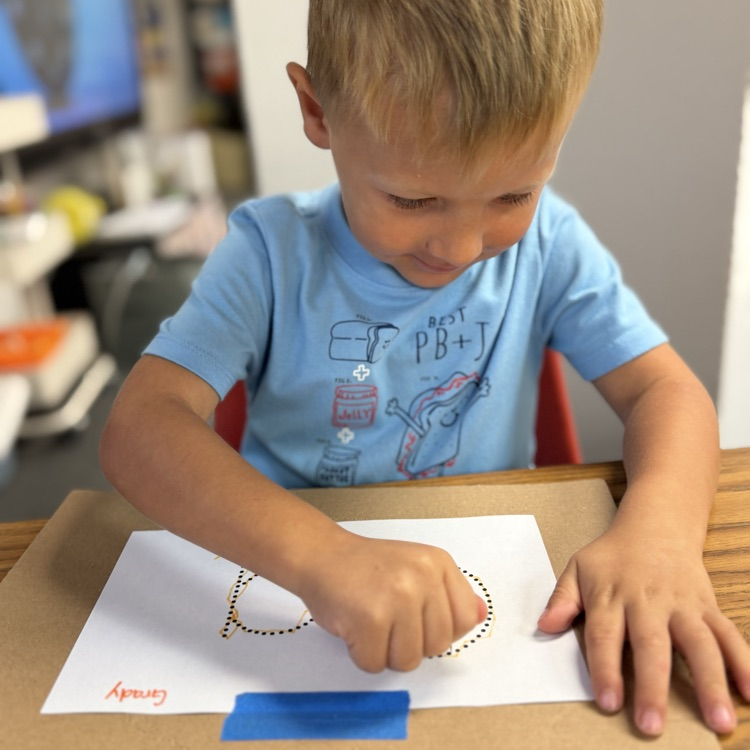 AM Preschool working on their fine motor skills.