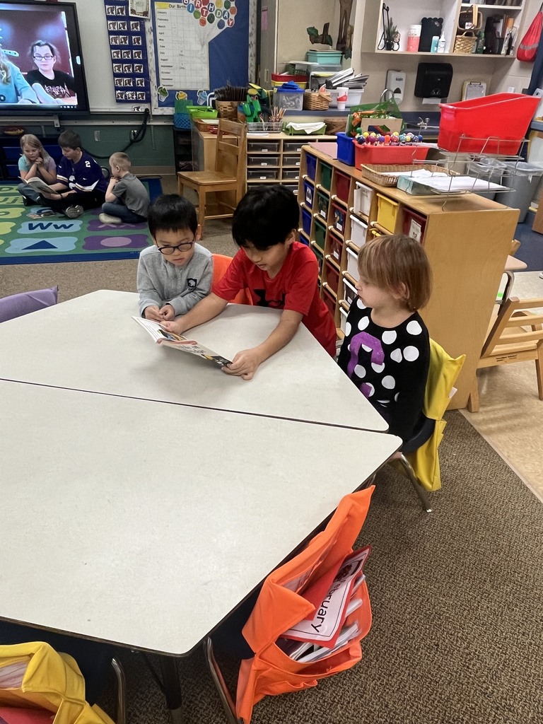 OES student council member reading to Kinderprep students.