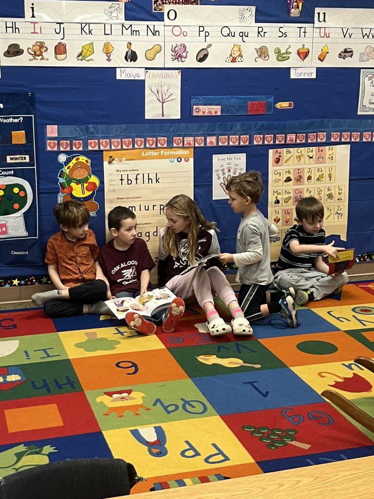 OES student council member reading to Kinderprep students.