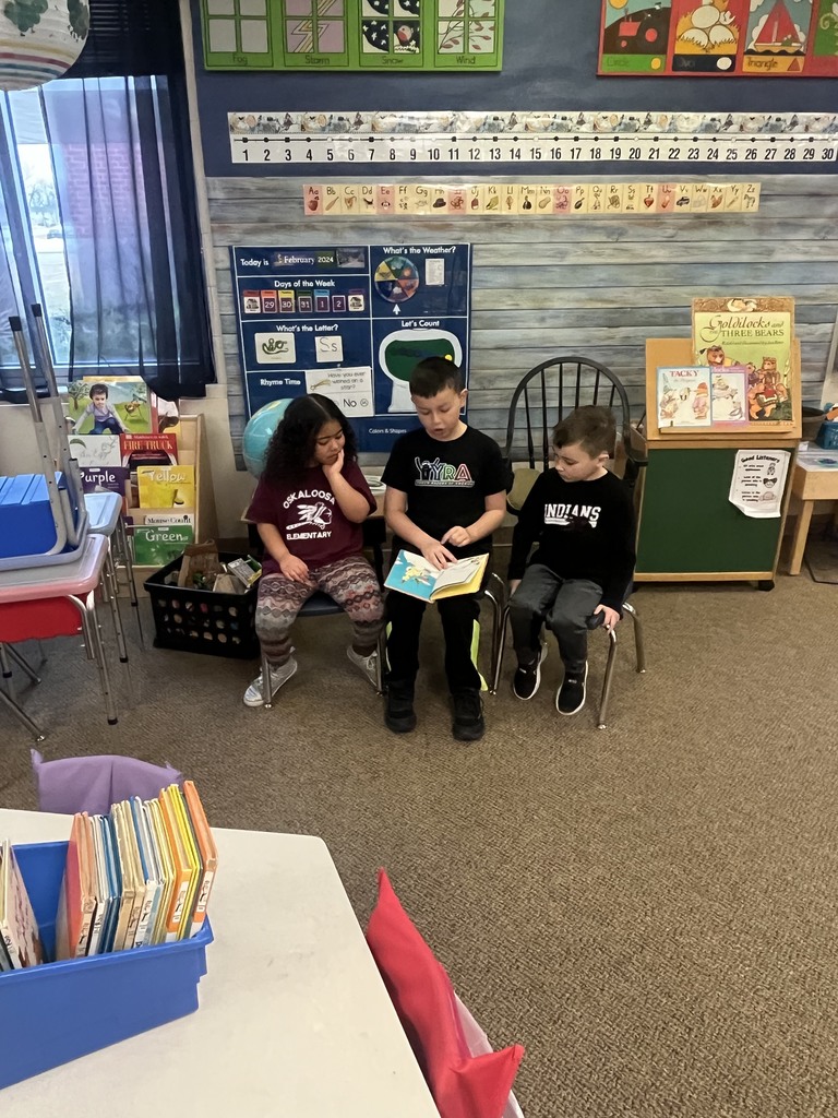 OES student council member reading to Kinderprep students.