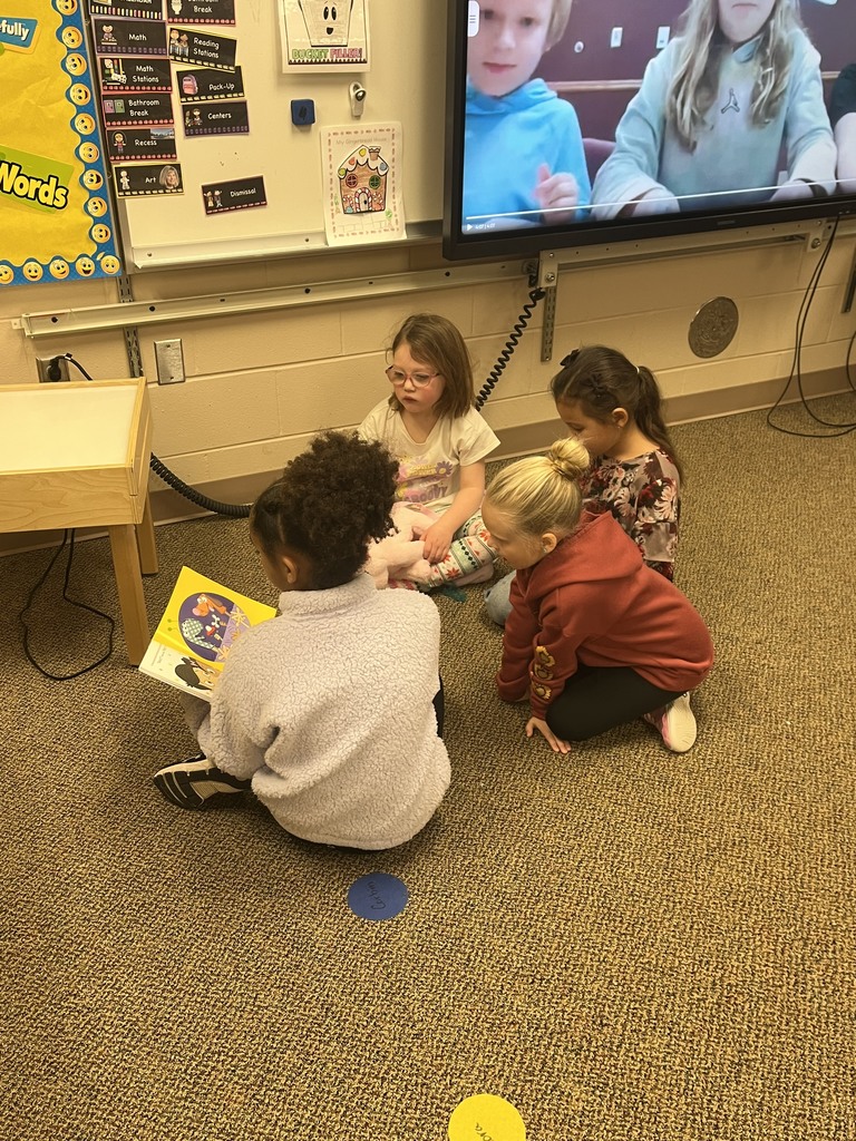 OES student council member reading to Kinderprep students.