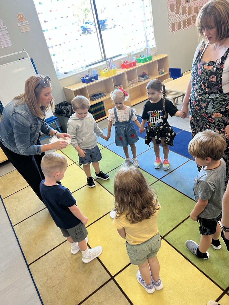 Oskaloosa preschoolers standing in a circle for a group activity.