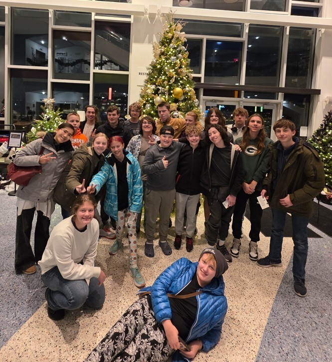 jazz band students in front of christmas tree