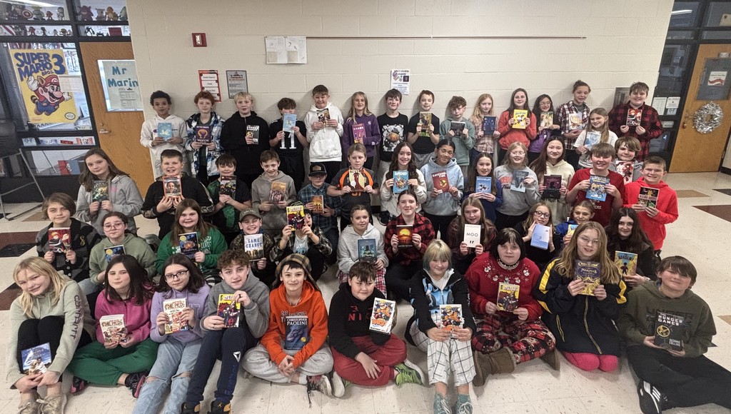 IMG_3943 six grade students holding new books
