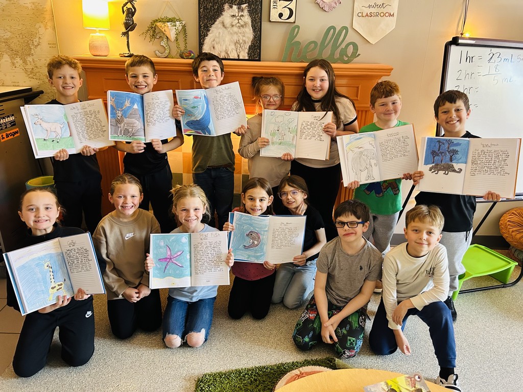 students displaying books