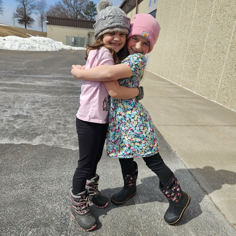 two girls at recess hugging