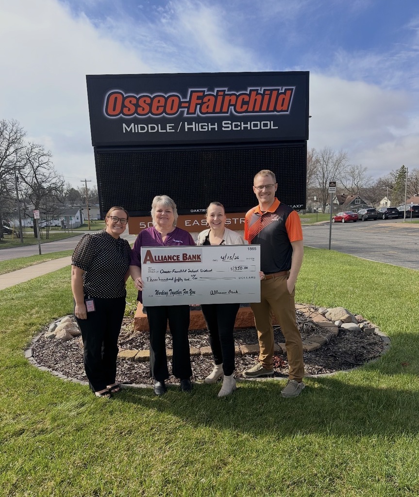 staff standing by sign holding check from alliance bank for $350