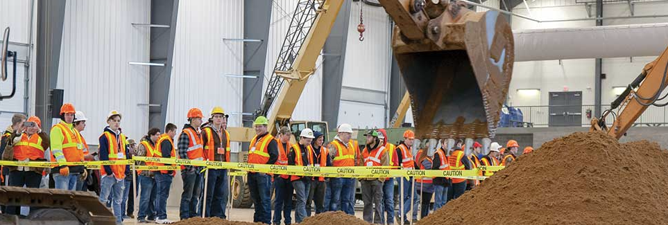 students watching large equipment work
