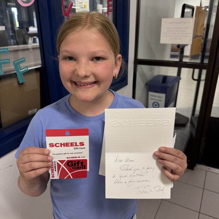 student holding letter and gift card 