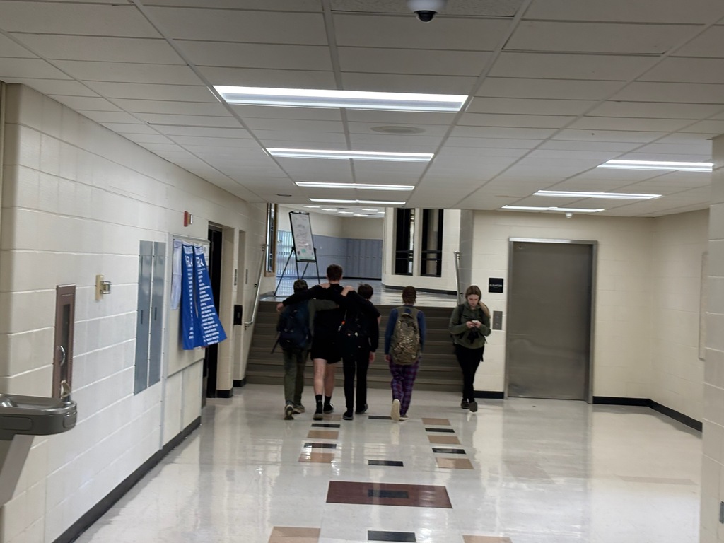 Ethan walking down the hall with younger students