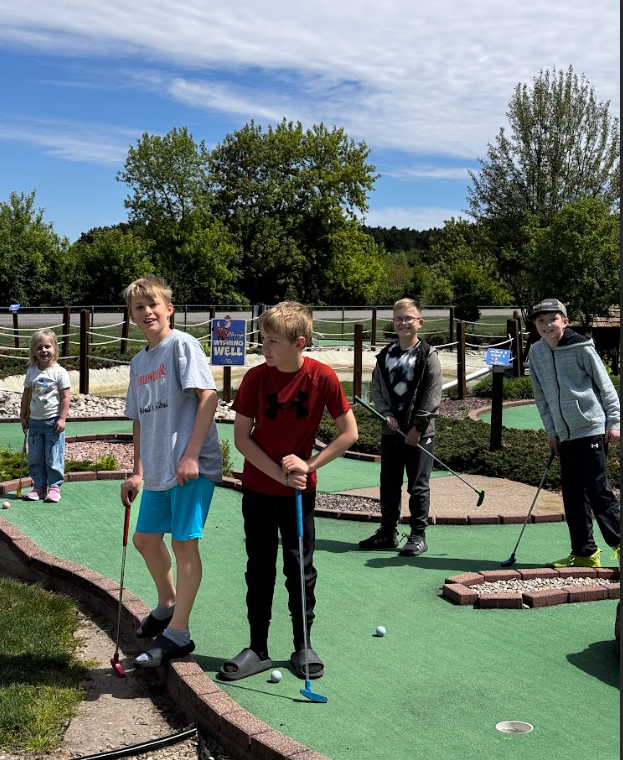 students playing mini golf