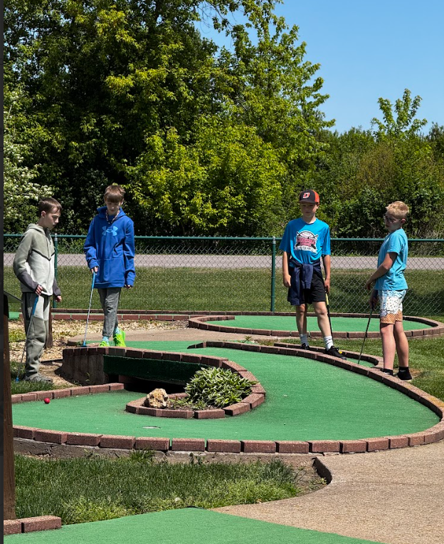 students playing minigolf