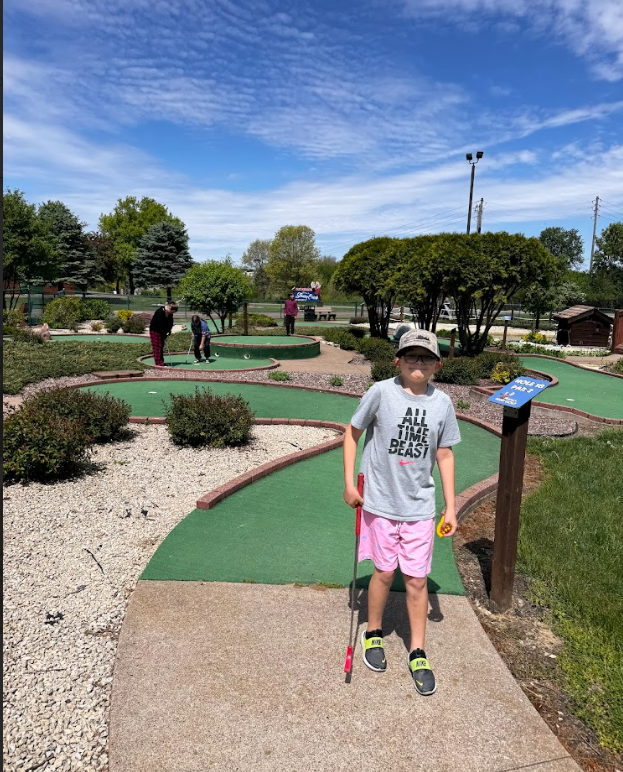 students playing mini golf