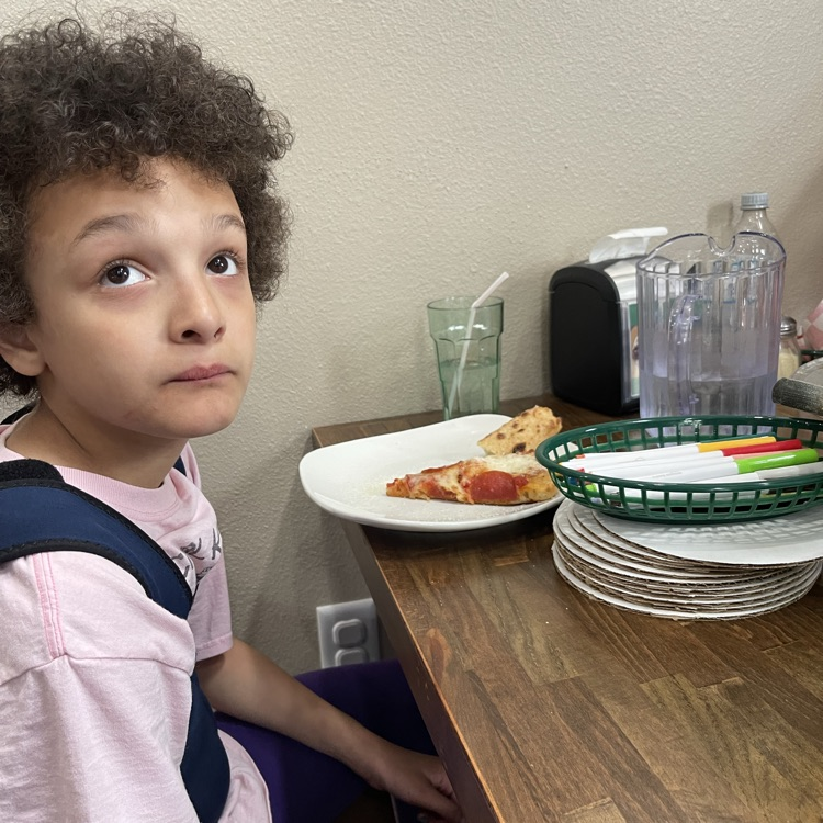student eating pizza
