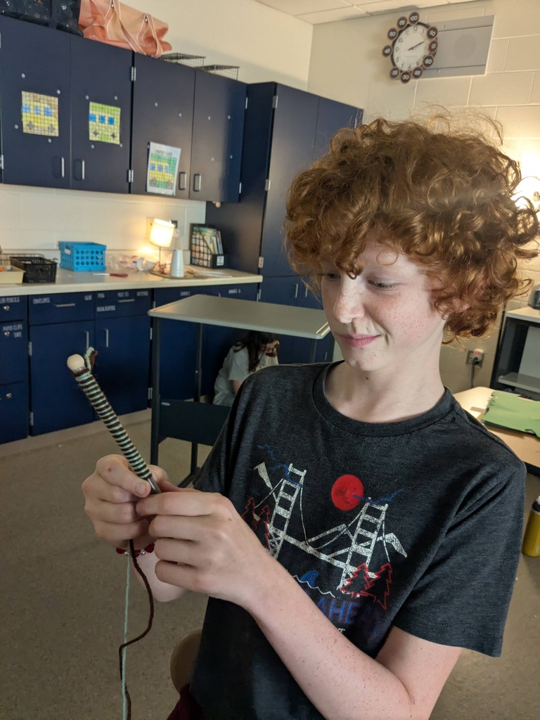 student making worry doll