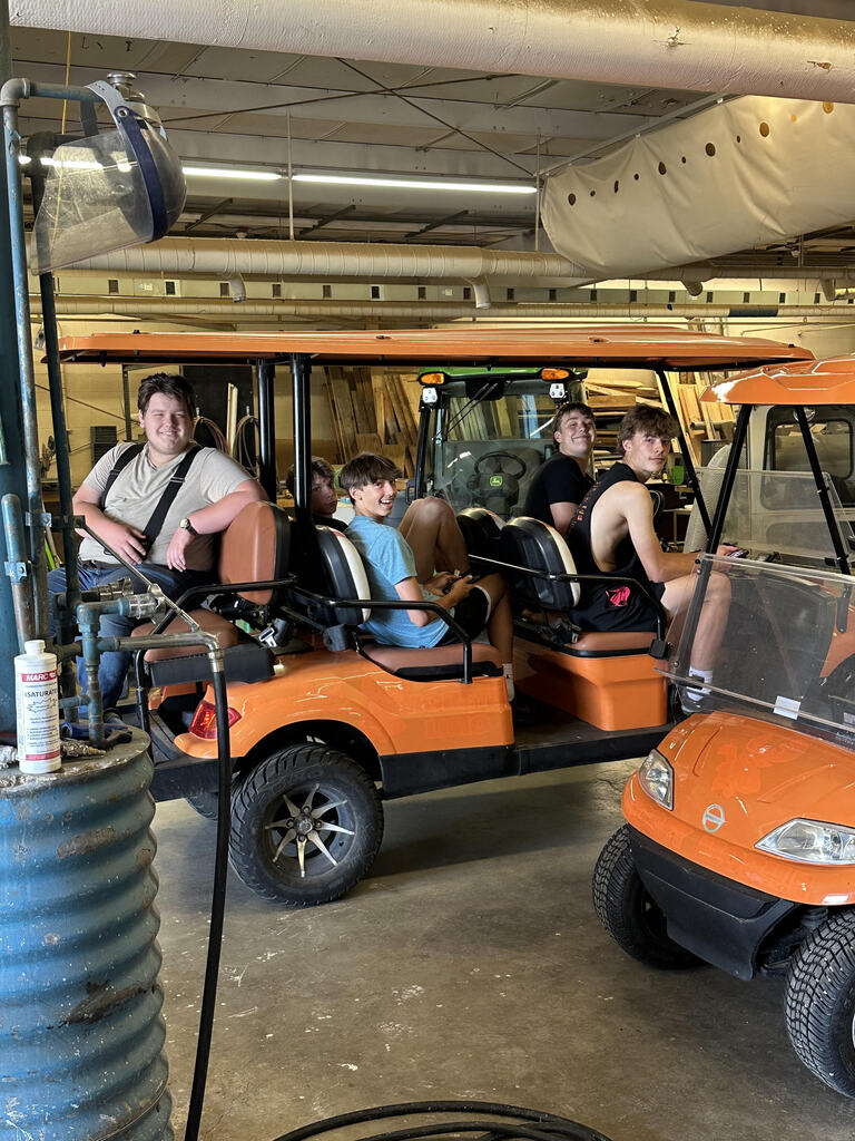 five boys sitting in ATV