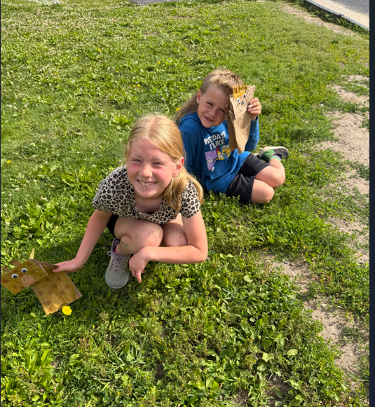 Students outside with animal puppets