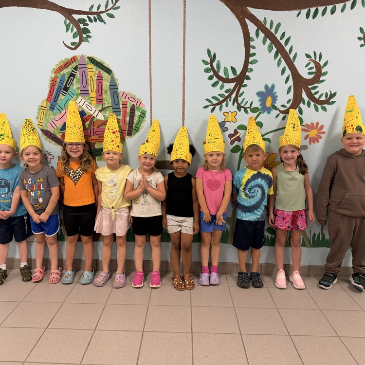 students posing with hats