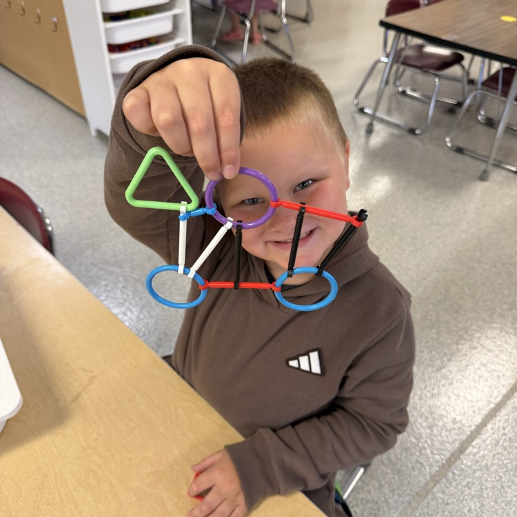 student holding up project 