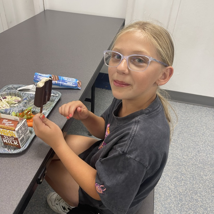 student eating icecream bar 