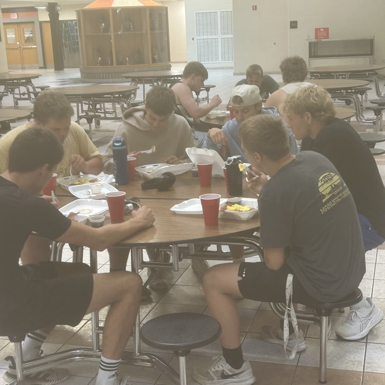 football players eating at table 