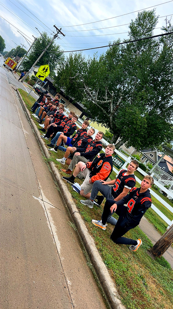 football players taking a knee along roadside