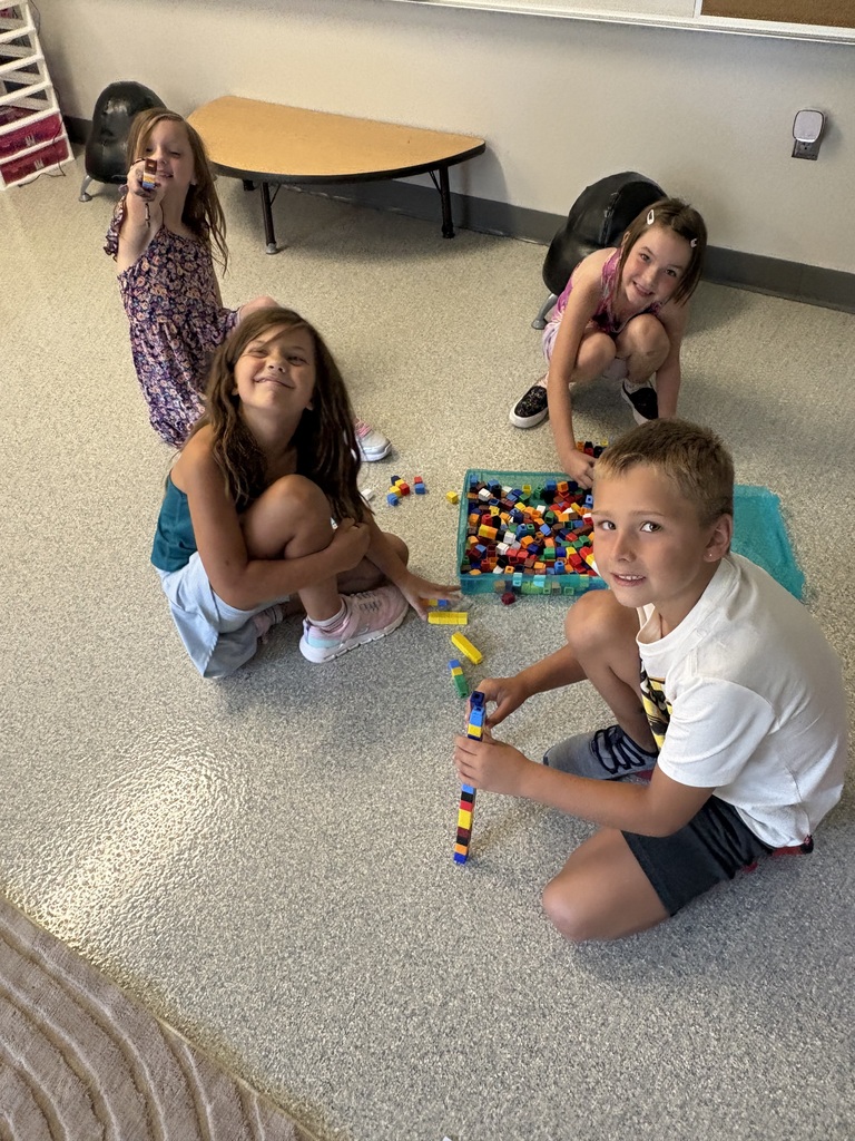four students working with cubes
