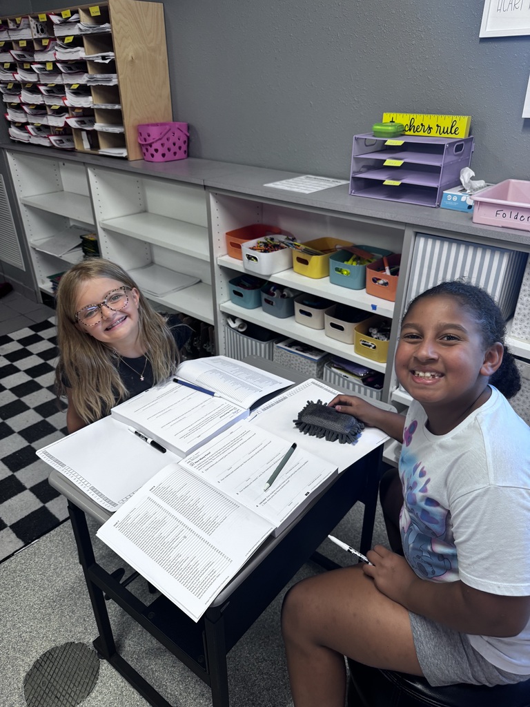 two girls working in math books