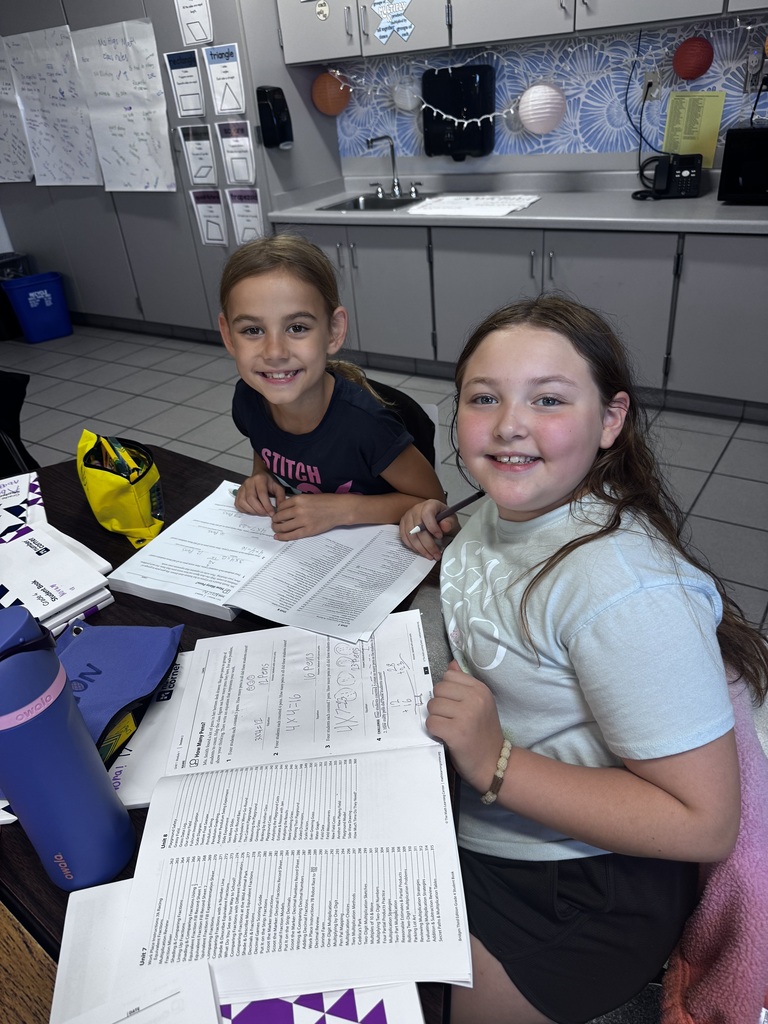 two girls working in math books