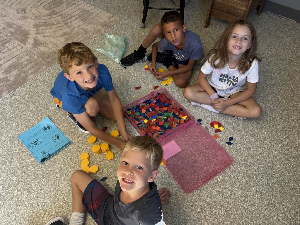 4 students working with math tiles