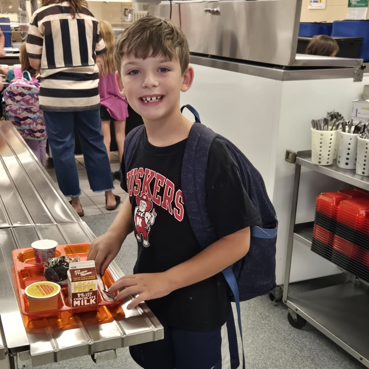 student with orange lunch tray