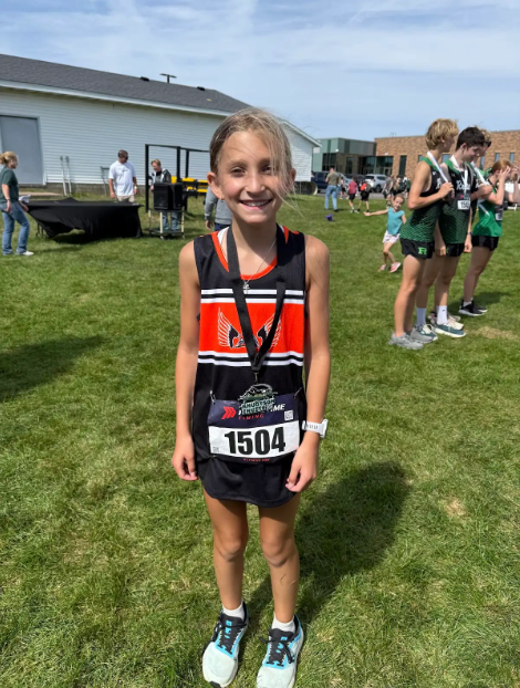 Reece Budik wearing medal from Cross Country race