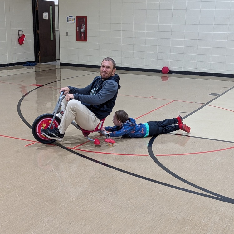 phy ed teacher riding bicycle dragging student behind 