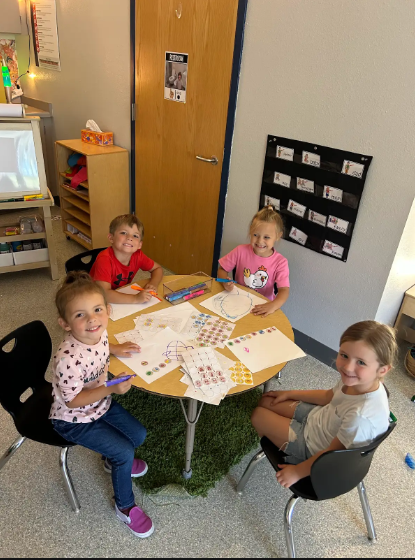 four students working at a table