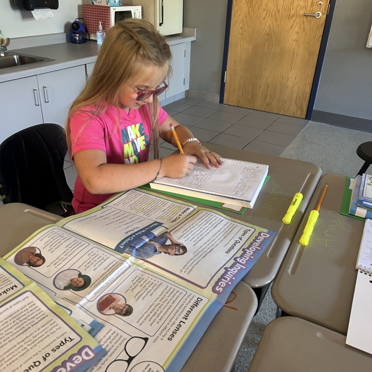 student writing in workbook