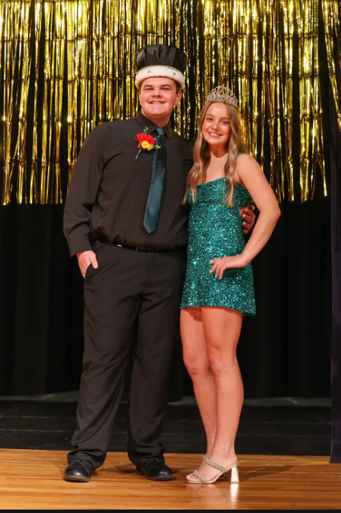 homecoming king and queen wearing crowns
