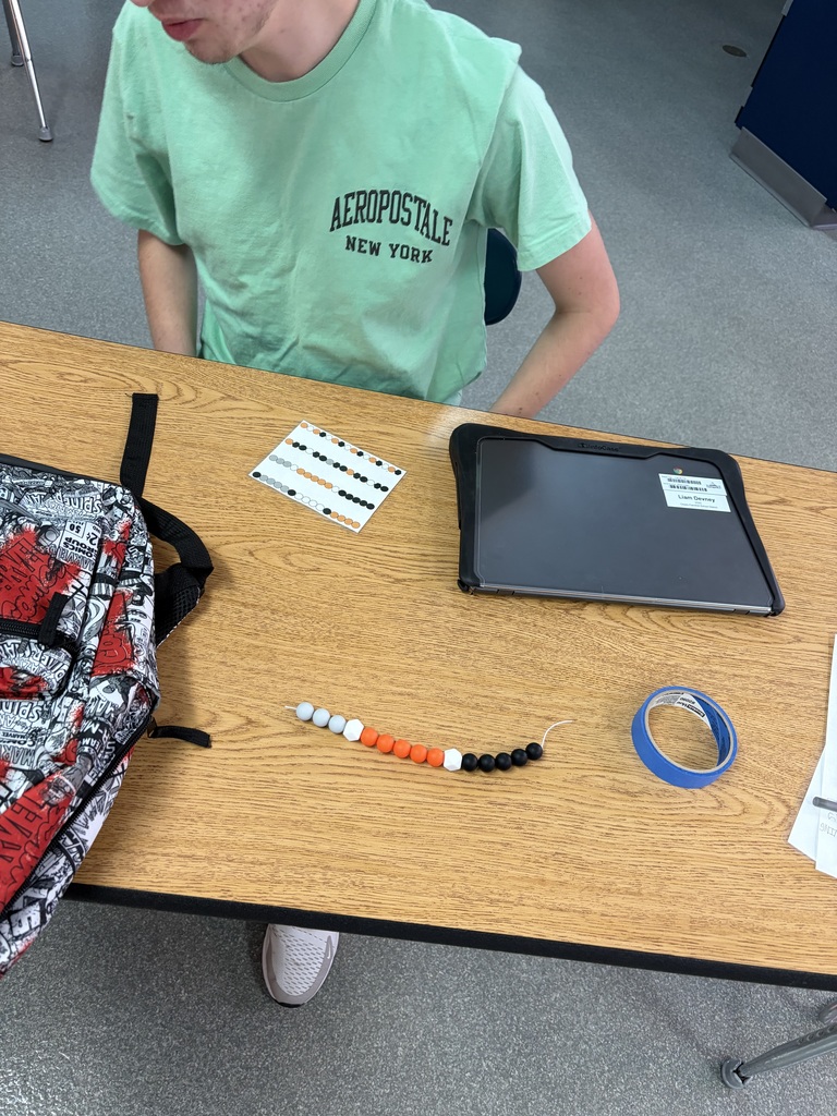 student doing beadwork