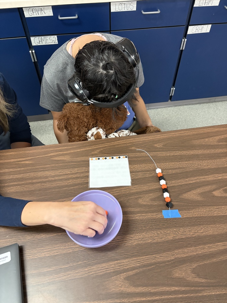 student doing beadwork