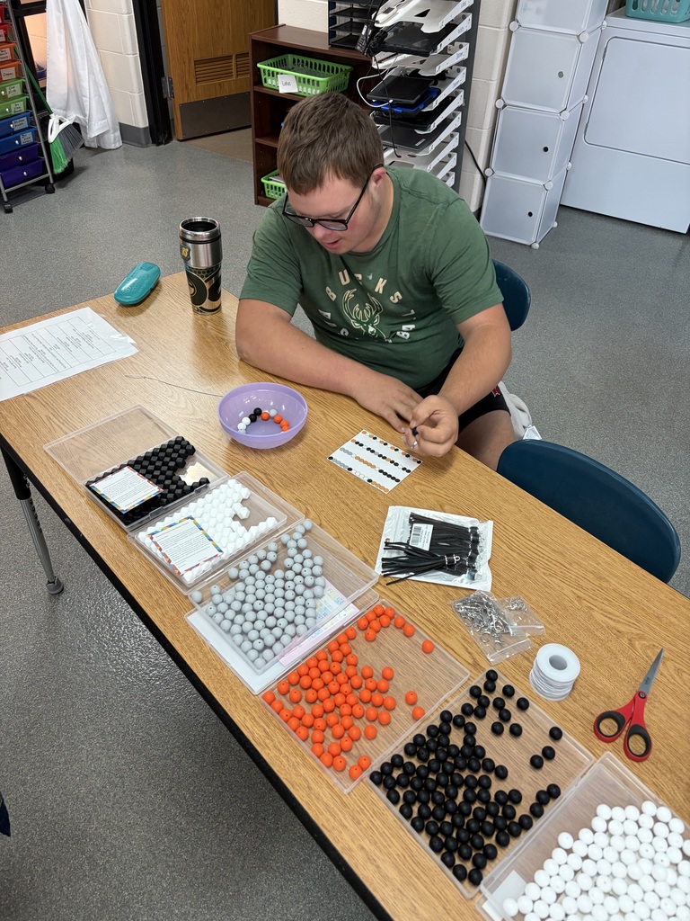 student doing beadwork