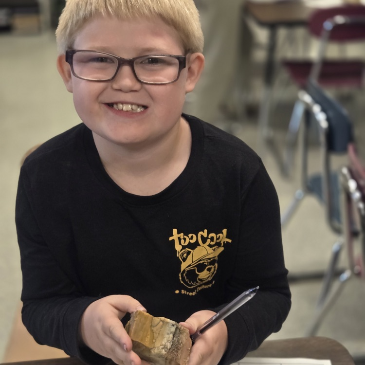 student holding rock